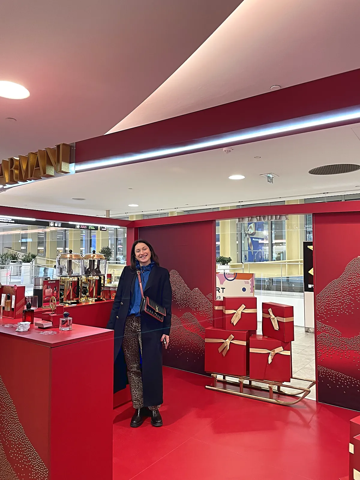 Corner de Noël Armani en galerie : coffrets cadeaux rouges et luge dorée